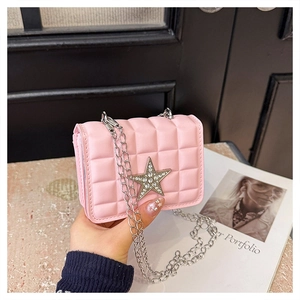 Close-up of pink quilted crossbody bag featuring a sparkling rhinestone star and metal chain