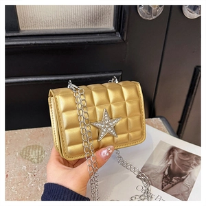 Detail of golden square bag with diamond star emblem and silver chain strap