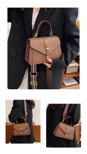 Detail of dark brown woven PU leather handbag with gold buckle and chevron shoulder strap