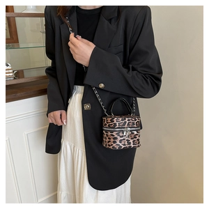 Chic leopard print mini cylinder bag styled with a professional black blazer outfit