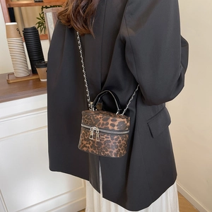 Fashionable leopard print bucket bag with chain strap styled with casual autumn outfit