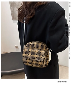 Detail of plaid mini crossbody bag featuring heart patterns and white rope strap