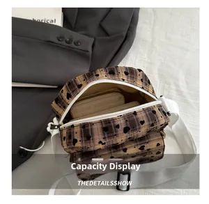 Macro view of plaid crossbody bag interior showing storage space for daily essentials