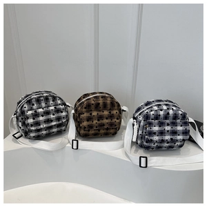 Three checkered heart-pattern shoulder bags in black, brown, and blue on white steps