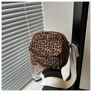 Macro detail of leopard print shoulder bag with white strap and adjustable buckle
