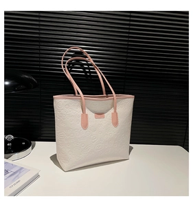 White and pink tote bag with embossed heart patterns and long shoulder strap for daily use