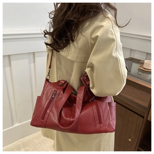 Retro burgundy leather tote bag styled with a beige trench coat for a classic casual look