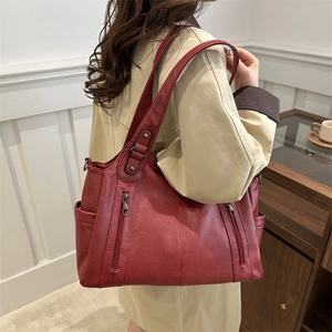 Vintage burgundy leather tote bag with vertical zippers and side pockets for women