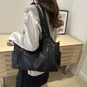 Chic black litchi pattern leather tote bag with double straps and vertical zippers