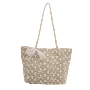 Straw woven tote bag with white floral embroidery and lace bow for summer beach