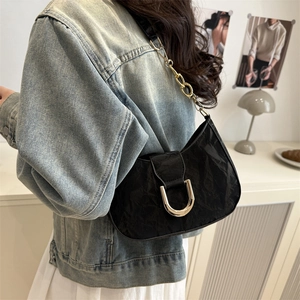 Chic black pleated crescent shoulder bag with gold metal buckle and chain strap