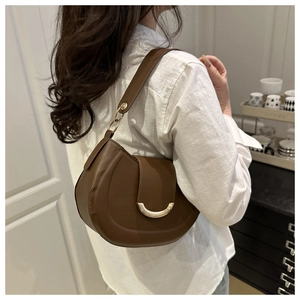 Brown leather saddle bag with gold buckle detail shown from a stylish side view angle