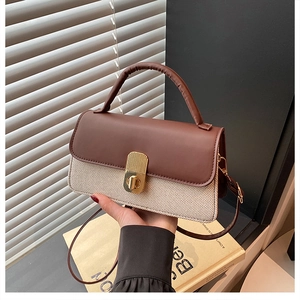 Detail of caramel brown contrast bag featuring a gold twist lock and woven texture