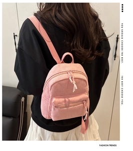 Pink corduroy mini backpack for women showing detailed texture and adjustable shoulder straps
