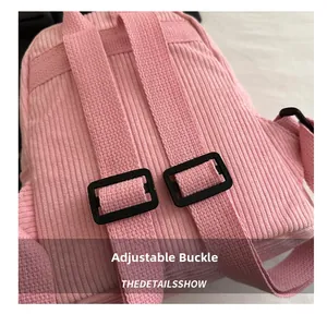 Detailed macro view of pink corduroy backpack with adjustable straps and plastic buckles