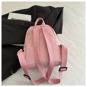 Close-up of pink corduroy mini backpack texture with adjustable shoulder straps