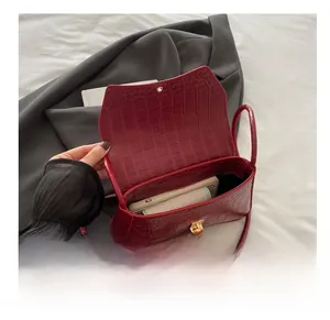 Detail view showing internal storage of red crocodile pattern PU leather crossbody bag