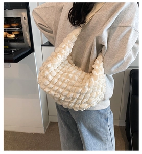 Close-up of cream white popcorn textured tote bag with unique 3D bubble fabric detail