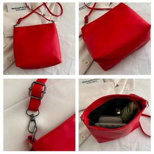 Detail view of red PU leather bag features, adjustable strap, and spacious interior capacity