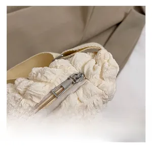Detailed close-up of premium silver zipper and textured fabric of the cloud bag