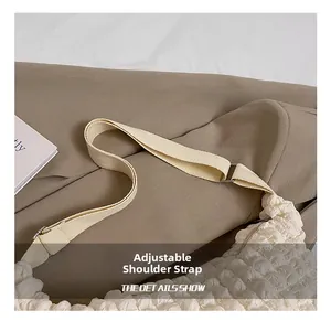 Detail of adjustable canvas strap and textured ruched fabric on the cloud tote bag