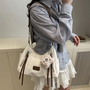 Grande borsa a tracolla bianco sporco con cinturini in pelle marrone e charm smiley