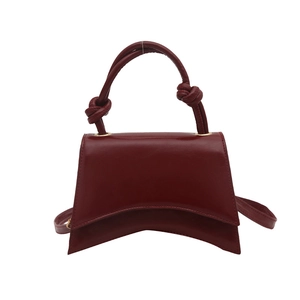 Retro dark red leather hourglass handbag with knotted handle and shoulder strap