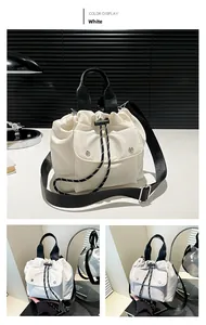Detail view of white nylon drawstring bucket bag with buckle pocket and woven handles
