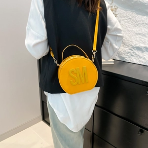 Chic yellow circular handbag with embossed SM letters and top handle for women