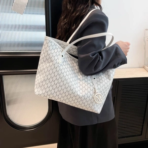 Large white quilted tote bag with repetitive M-letter print and stylish metal charm