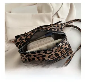 Detailed interior of the leopard print crossbody bag showing large capacity for phone and wallet