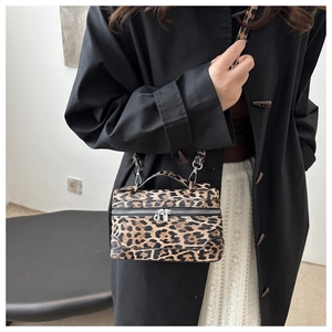 Detail of vintage leopard print box bag with metal zipper and adjustable crossbody strap
