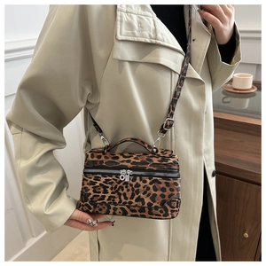 Leopard print crossbody bag shown worn over a beige coat for a stylish autumn look