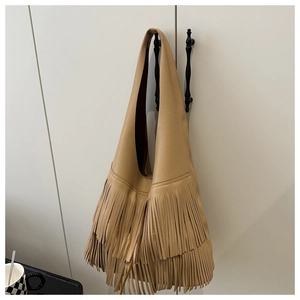 Close-up of khaki tote bag featuring multi-layer long tassels and pebbled leather texture