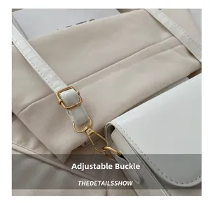 Detail of adjustable white leather strap with golden buckle and metal lobster clasp