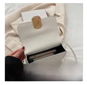 Interior view of white crossbody bag showing storage capacity for phone and wallet