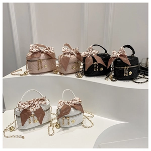 Detailed view of mini quilted crossbody bags in pink, black, and white with leopard scarves
