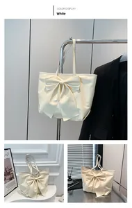 Détail d'un grand cabas blanc avec un nœud décoratif et un intérieur spacieux