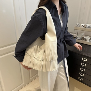 Chic beige hobo shoulder bag with tiered leather tassels and soft lychee pattern texture