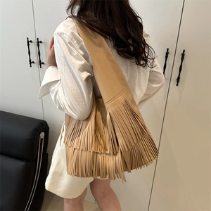 Khaki pebbled leather shoulder bag featuring double-layered long fringe bohemian style