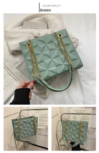 Close-up of green chain shoulder bag with geometric quilted pattern and gold metal strap