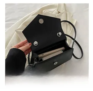 Interior view of black leather crossbody bag showing capacity for phone and card holder