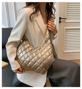 Close-up of champagne gold quilted hobo bag with sleek padded rhombic stitching