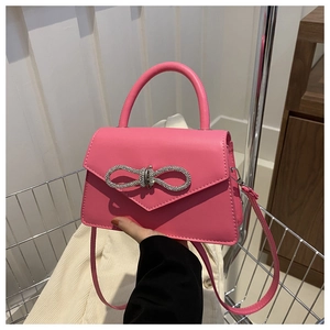 Barbie pink crossbody bag with sparkling rhinestone bow detail and fixed top handle