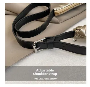 Detail of black leather adjustable shoulder strap with silver buckle on quilted tote bag