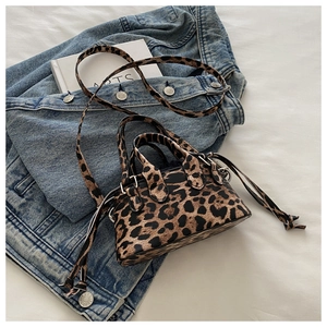 Detail of leopard print mini Boston bag with dual handles and side drawstring accent