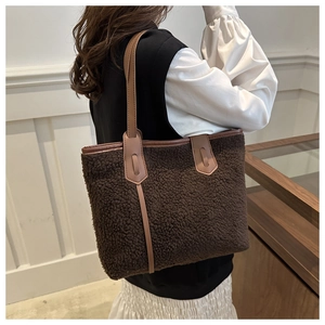 Détail du sac cabas en peluche marron foncé avec lanières en cuir et garniture