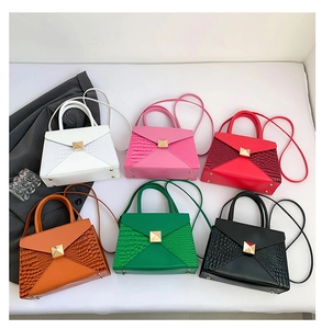Multi-color crocodile pattern handbags with gold square studs in envelope style display