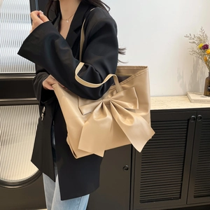 Fashionable beige large capacity tote bag with oversized bow detail and shoulder strap