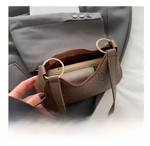 Interior view of brown faux crocodile hobo bag with gold hardware showing storage capacity